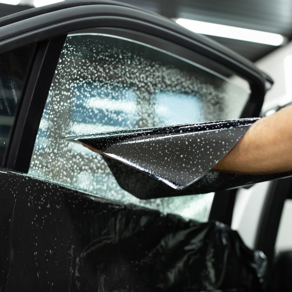 Car window tinting series: Installation of car window tinting. Detailing studio.